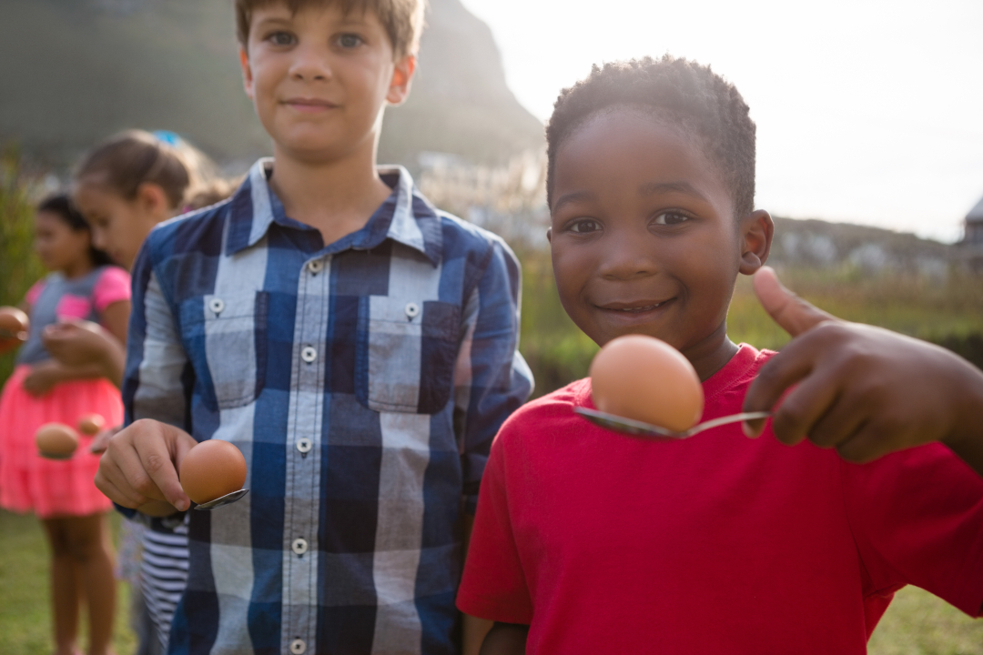 Portrait of boys playing egg and spoon race